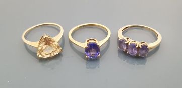 Two 9 carat gold dress rings and an 18 carat gold and rhodolite garnet set dress ring,