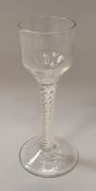 A late 18th/early 19th Century wine glass with ogee bowl on a double series opaque twist decorated