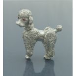 A mid 20th Century 14 carat white gold brooch in the form of a poodle with ruby set eyes and