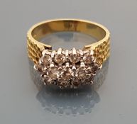 An 18 carat gold bark effect ring with diamond cluster of thirteen diamonds,