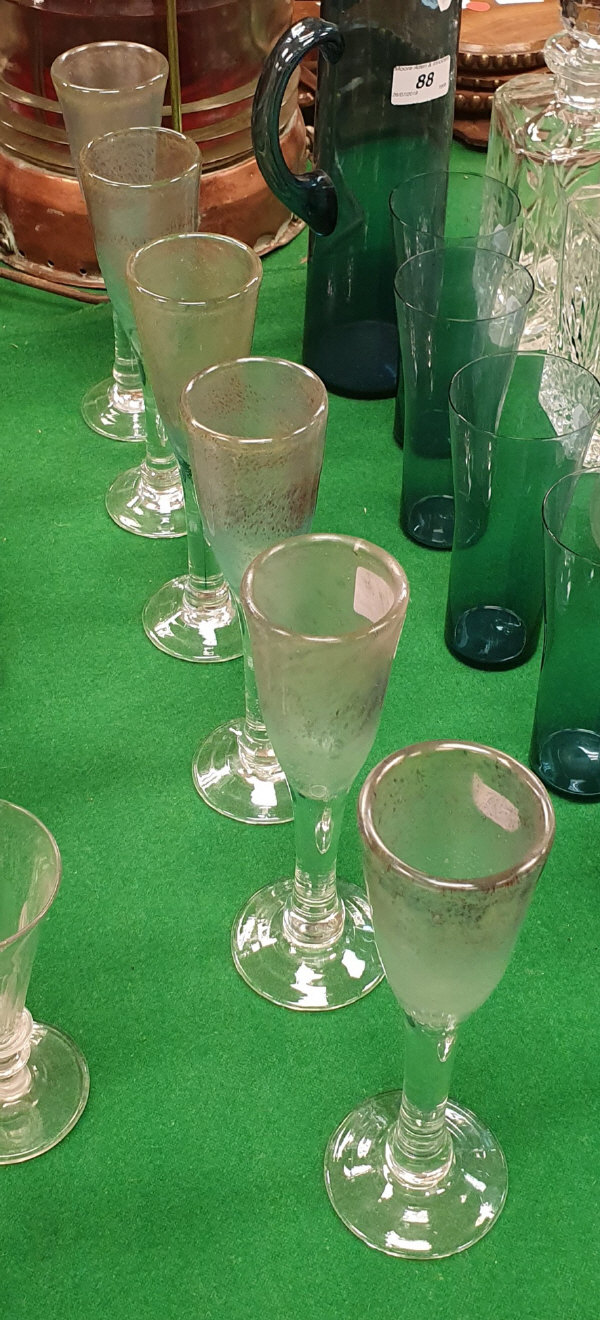 A set of six Tysoe glass flutes of iridescent bubble form raised on a circular foot