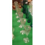 A set of six Tysoe glass flutes of iridescent bubble form raised on a circular foot