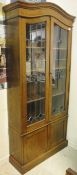 An early 20th Century oak and leaded glazed display cabinet,