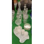 A collection of six various cut glass decanters/ewers, five facet cut jars and covers,