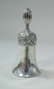 A silver table bell with scrolling acanthus band decoration and bearing monogram "A.S.