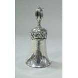 A silver table bell with scrolling acanthus band decoration and bearing monogram "A.S.