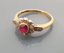 A gold mounted ruby and diamond flower head ring with diamond set shoulders, ring size Q, 3.