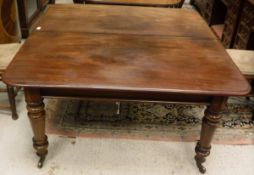 A Victorian mahogany rounded rectangular extending dining table with extra leaf