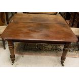 A Victorian mahogany rounded rectangular extending dining table with extra leaf