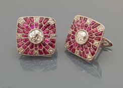 A pair of 18 carat gold ruby and diamond set earrings, each earring set with a central diamond 0.