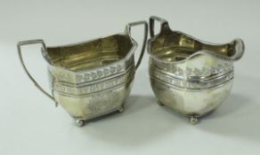 A George III silver cream jug of elongated octagonal form,