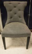 A set of four modern grey buttoned and studded upholstered chairs in the Etruscan style,