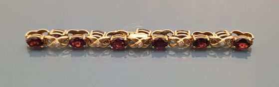 A 9 carat gold garnet and diamond set bracelet, total weight approx 10.