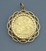 A 1909 gold sovereign, in yellow metal mount. Approx. 11.