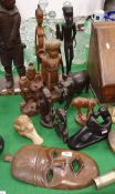 A collection of various carved wood and other sculptural figures including African and Oriental