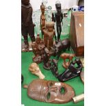 A collection of various carved wood and other sculptural figures including African and Oriental