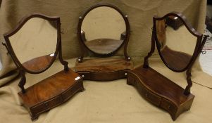 A 19th Century mahogany oval-shaped toilet mirror on serpentine-fronted three-drawer base with