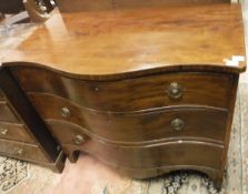 A 19th Century mahogany serpentine fronted chest of three long drawers on bracket feet