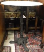 A marble-topped cast iron pedestal pub type table