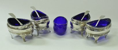 A set of four Regency silver oval open salts with cabriole legs and Bristol blue liners,