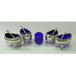 A set of four Regency silver oval open salts with cabriole legs and Bristol blue liners,