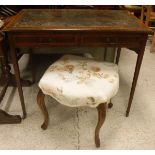 An Edwardian mahogany two drawer writing table on square tapered legs to castors,