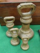 A graduated set of four Avery Ltd brass bell weights 14 lbs, 4 lbs,