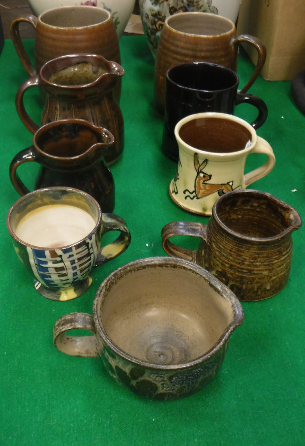 A collection of various studio pottery including two Poole Sylvan ware M70 mugs,