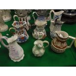 A collection of matt biscuit fired relief work jugs including a William Brownfield baluster shaped