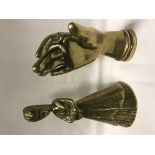 A vintage solid cast brass hand with Masonic ring and ornate cuff as a paperweight,