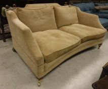 A modern fawn upholstered Knole style sofa, with swept arms and concave front rail,
