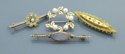 Four various gold brooches, to include a ruby and pearl set brooch in the Victorian taste,