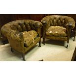 A pair of Victorian button back leather upholstered tub chairs,