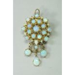 A 14 carat gold and opal set pendant / brooch,