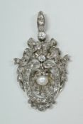 A Belle Epoque diamond set pendant with central scallop shaped hinged droplet, set with a pearl,