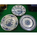 An 18th Century Dutch Delft ware charger decorated with a harbour entrance scene with sailing