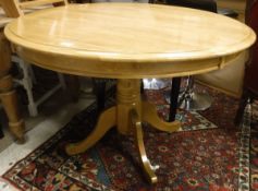 A modern stained beech pedestal breakfast table on quadruped base,