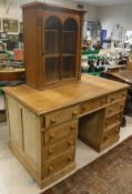 A modern pine pedestal desk, the plain top over two banks of four drawers and central drawer,