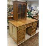 A modern pine pedestal desk, the plain top over two banks of four drawers and central drawer,