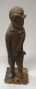 A 19th Century carved wooden figure of a young boy in cap and shorts