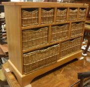 A modern pine side cabinet with multiple basket drawers,