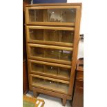 A 1950's oak Staverton bookcase cabinet with five glazed doors and Wellington style side plate