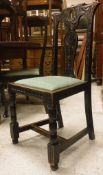 A set of six Victorian carved oak dining chairs