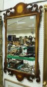 A 20th Century burr yew and marquetry inlaid fretwork carved wall mirror in the Georgian manner