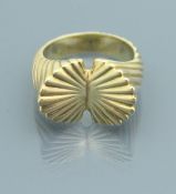 A 14 carat gold mid 20th Century ring of textured flared form, ring size P/Q, 14.