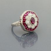 An 18 carat white gold ruby and diamond set cluster ring of flower head form, ring size O,