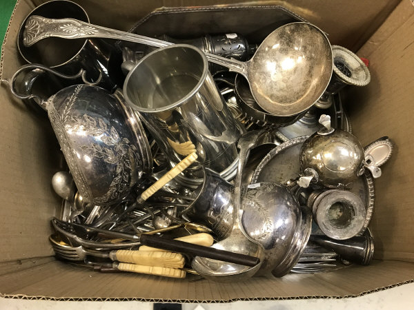 A box containing assorted plated wares to include cutlery, sugar caster, chamber sticks,