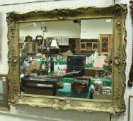 A large 18th Century style giltwood and gesso framed wall mirror,