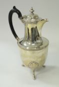 A late Victorian silver water jug of urn form,