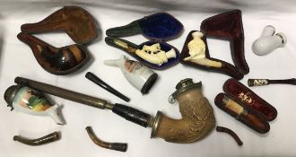 A collection of various pipes to include a Continental Meerschaum pipe with white metal cover,